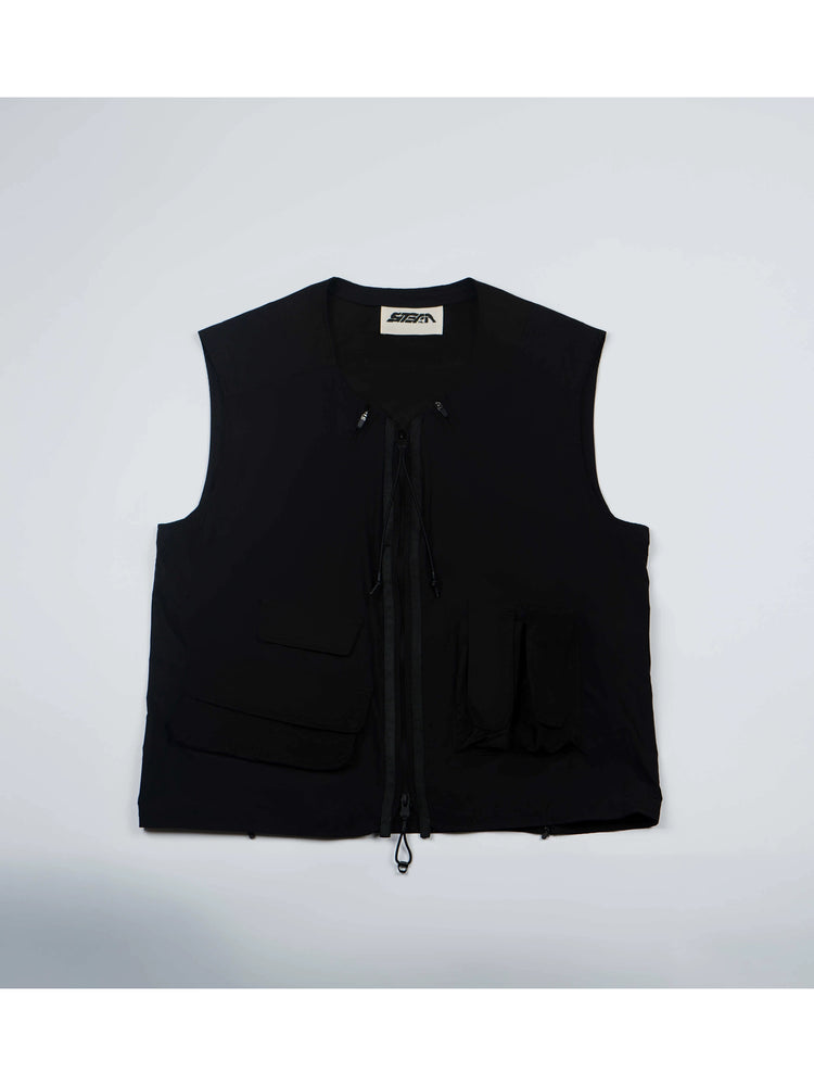 CLERIC utility nylon vest in stardust black — front flat-lay showing the asymmetric pockets and double-ended zip