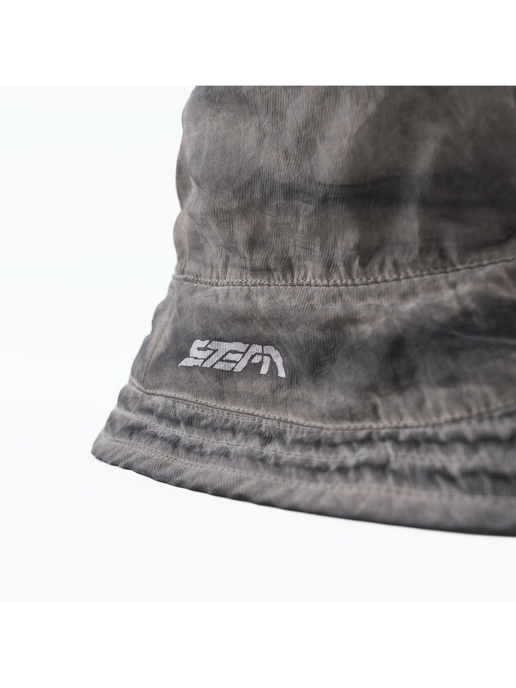 PIONEER distressed nylon bucket hat in moon dust gray — close-up of the logo and crown seam