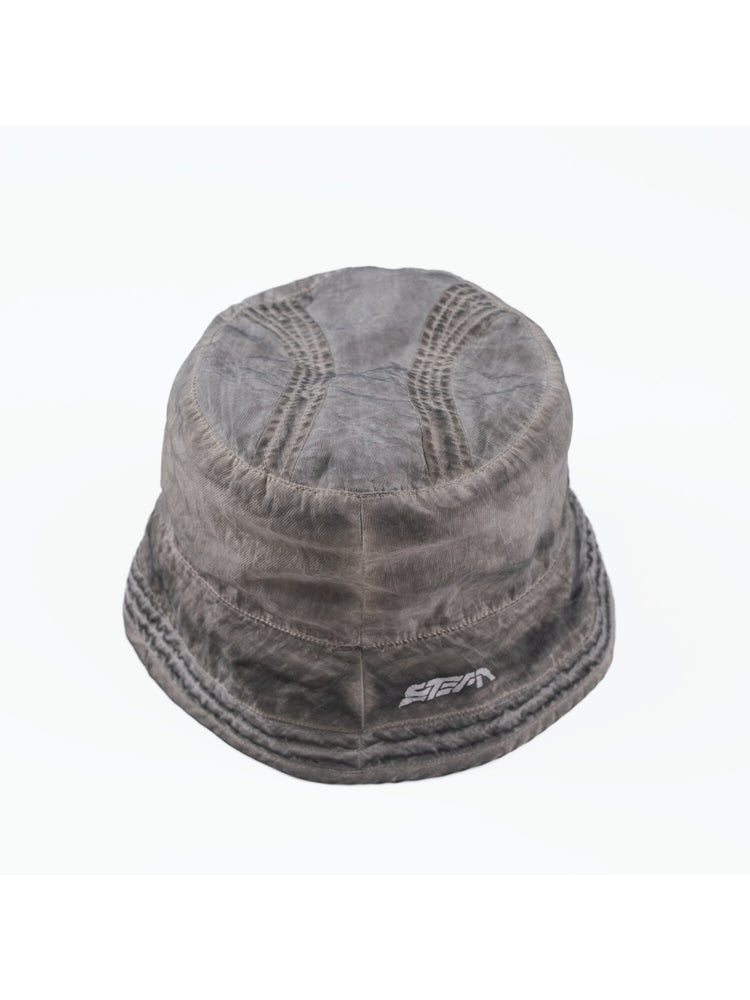 PIONEER distressed nylon bucket hat in moon dust gray — overhead garment-only view of the crown panels