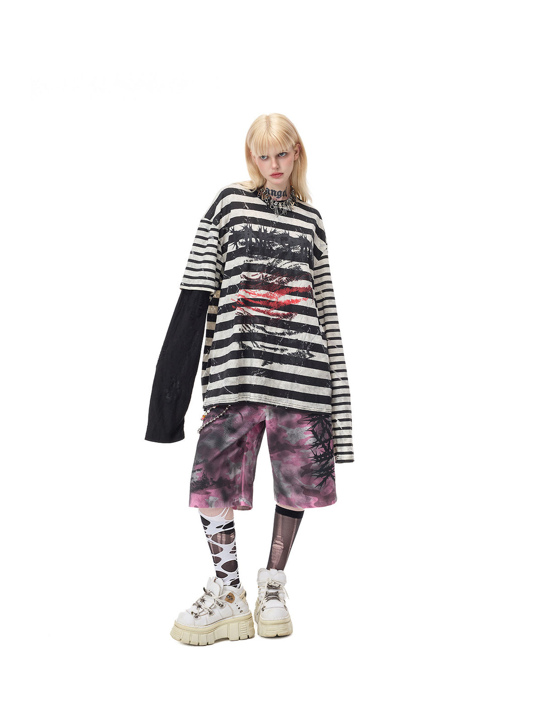 PINKSPINK STATIC asymmetric striped burnout long-sleeve tee in black and white — angled full-length front modeled view over separate pink camouflage shorts
