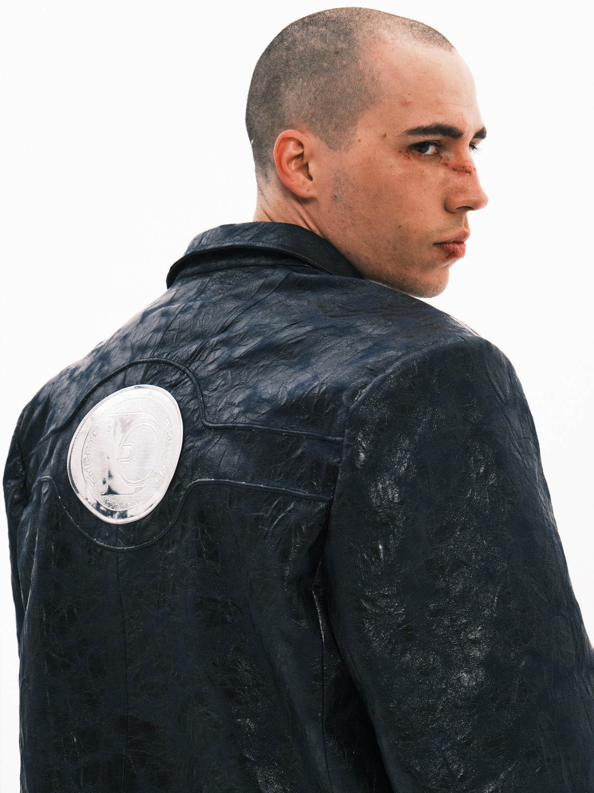 EMBRYO HORN CODE textured PU leather blazer — back emblem detail