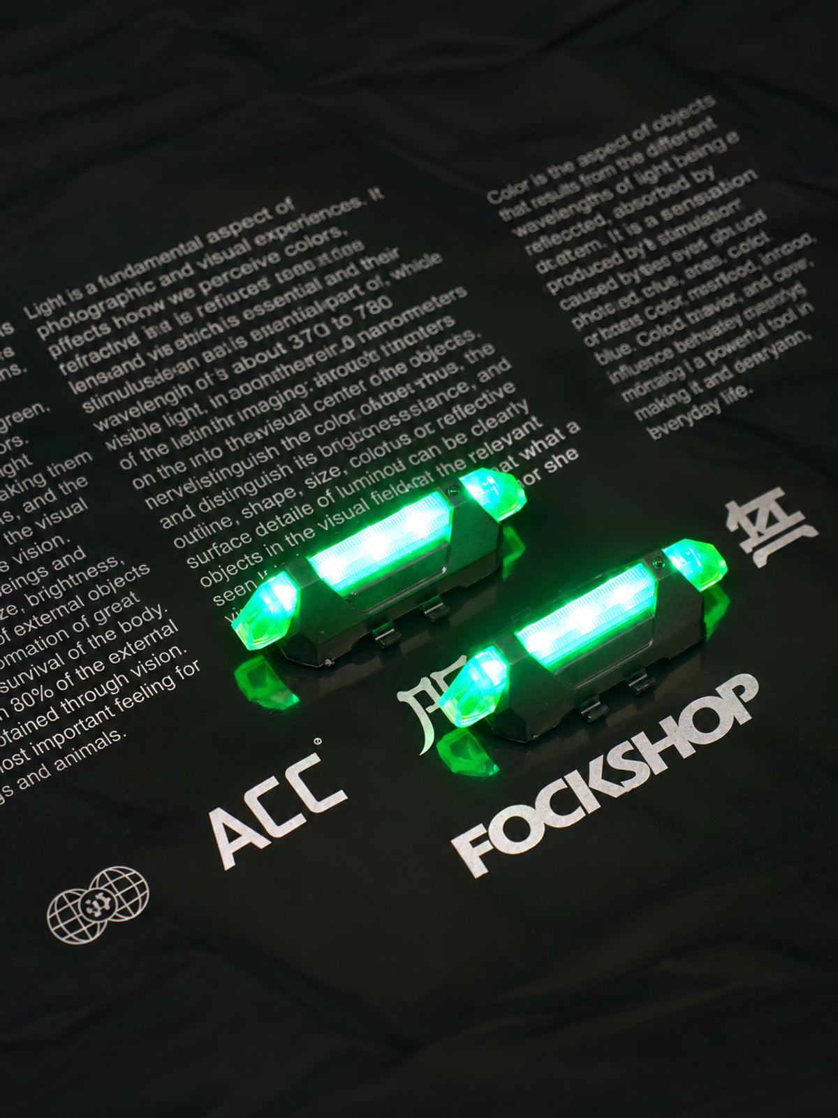 FOCKSHOP TRAIN L rechargeable costume light pair — green illuminated pair from above