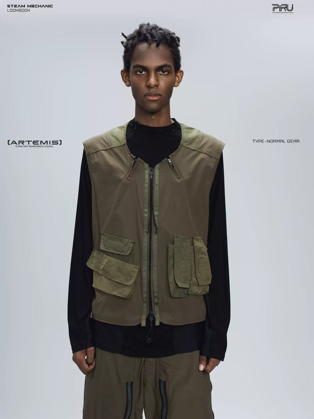 CLERIC utility nylon vest in vine gray green — front modeled close-up showing olive panels and asymmetric pockets