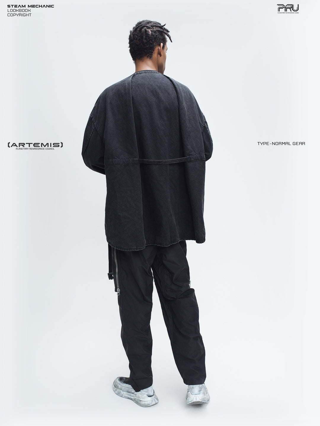 GAIA curved-blade technical pants in black — full-length rear styling view with a matching jacket