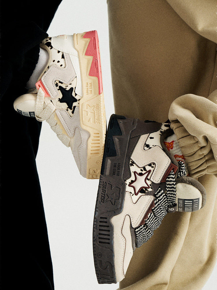 STARTER ZOO Cow Pink sneaker on the left beside a separate Zebra Gray design in an on-foot side view