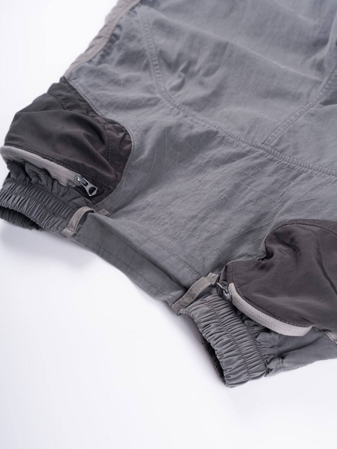 SUPERNOVA alloy gray metallic nylon technical pants — alloy gray close-up of the gathered waist, stitched panels and belt loops