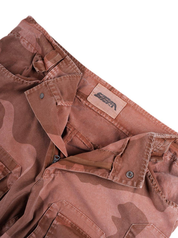 IXION washed camouflage combat pants in dune red — detail of the inside waistband, snap fastening and brand label