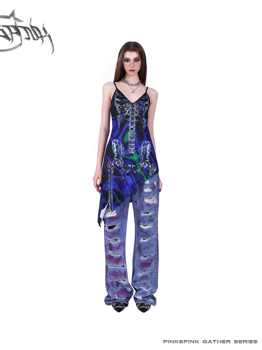 PINKSPINK COSMOS skeleton-print asymmetric slip dress in blue green multicolor — alternate front full-length modeled view layered over jeans