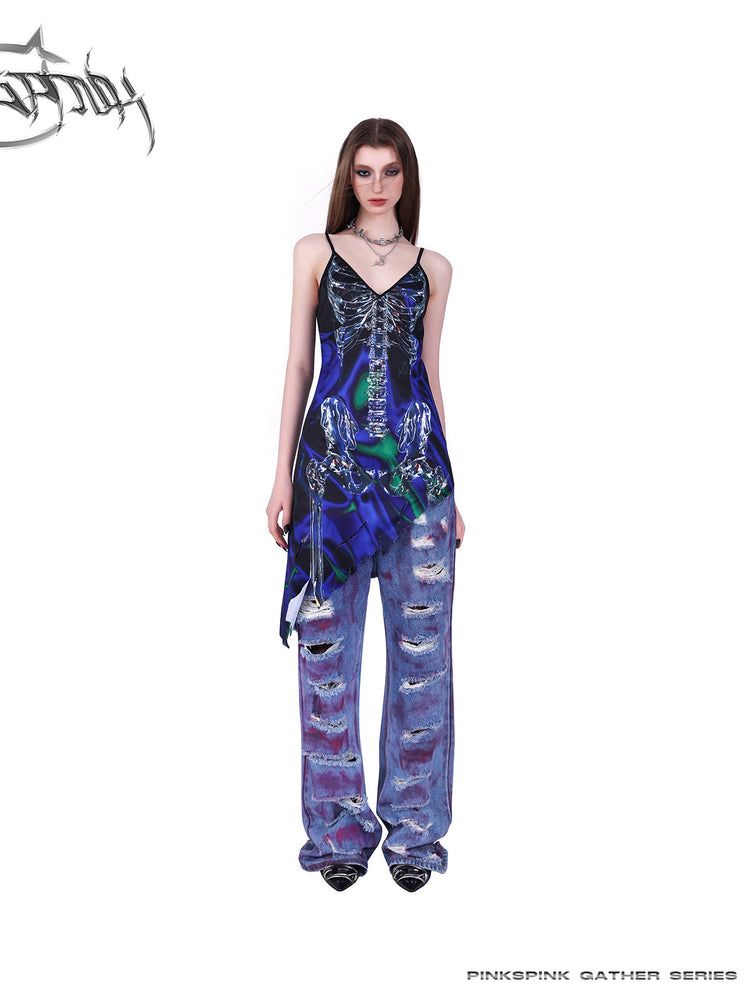 PINKSPINK COSMOS skeleton-print asymmetric slip dress in blue green multicolor — alternate front full-length modeled view layered over jeans