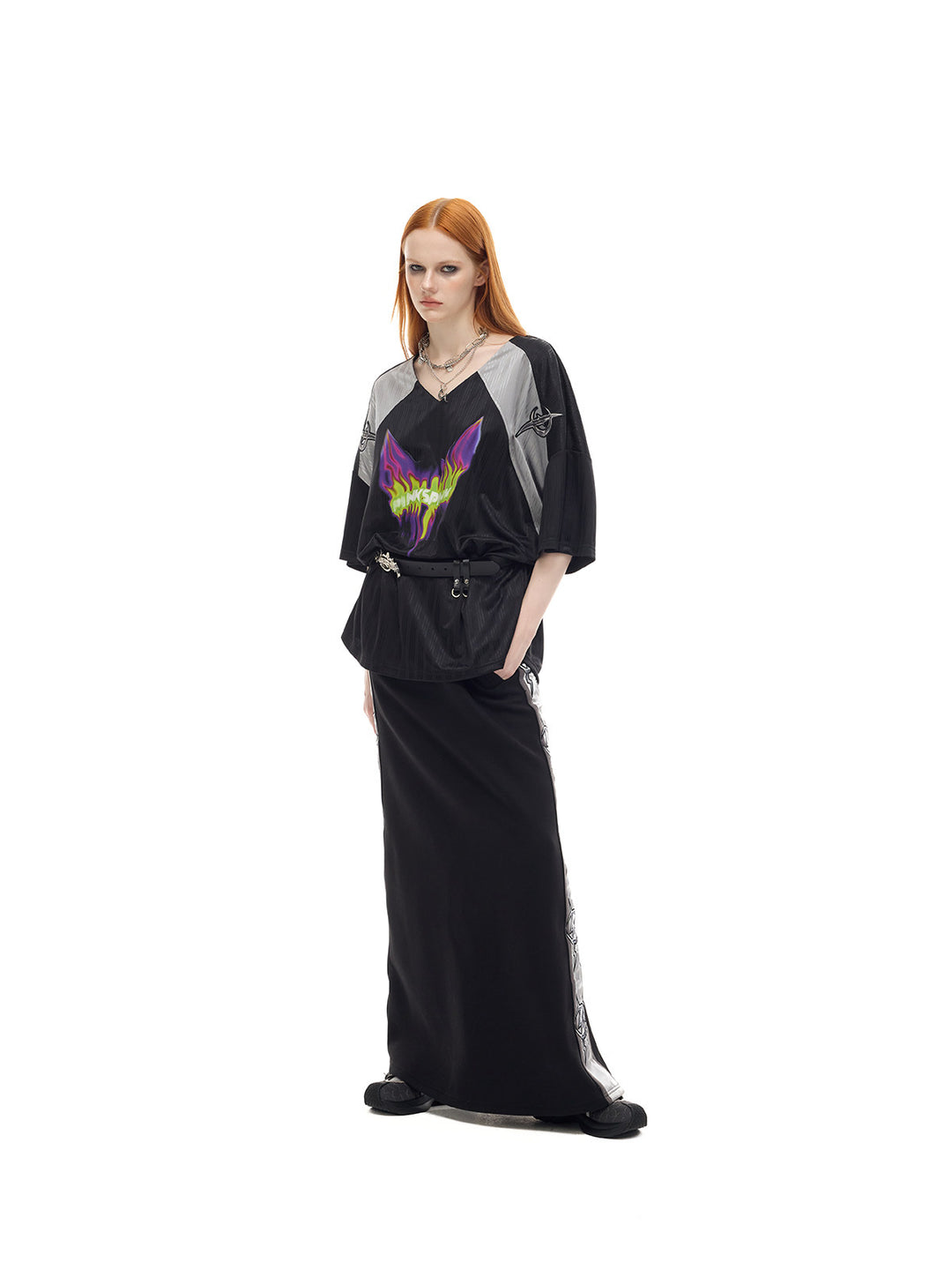 PINKSPINK FLAMECAT oversized sports jersey in black and gray — angled full-length belted view styled with a separate maxi skirt