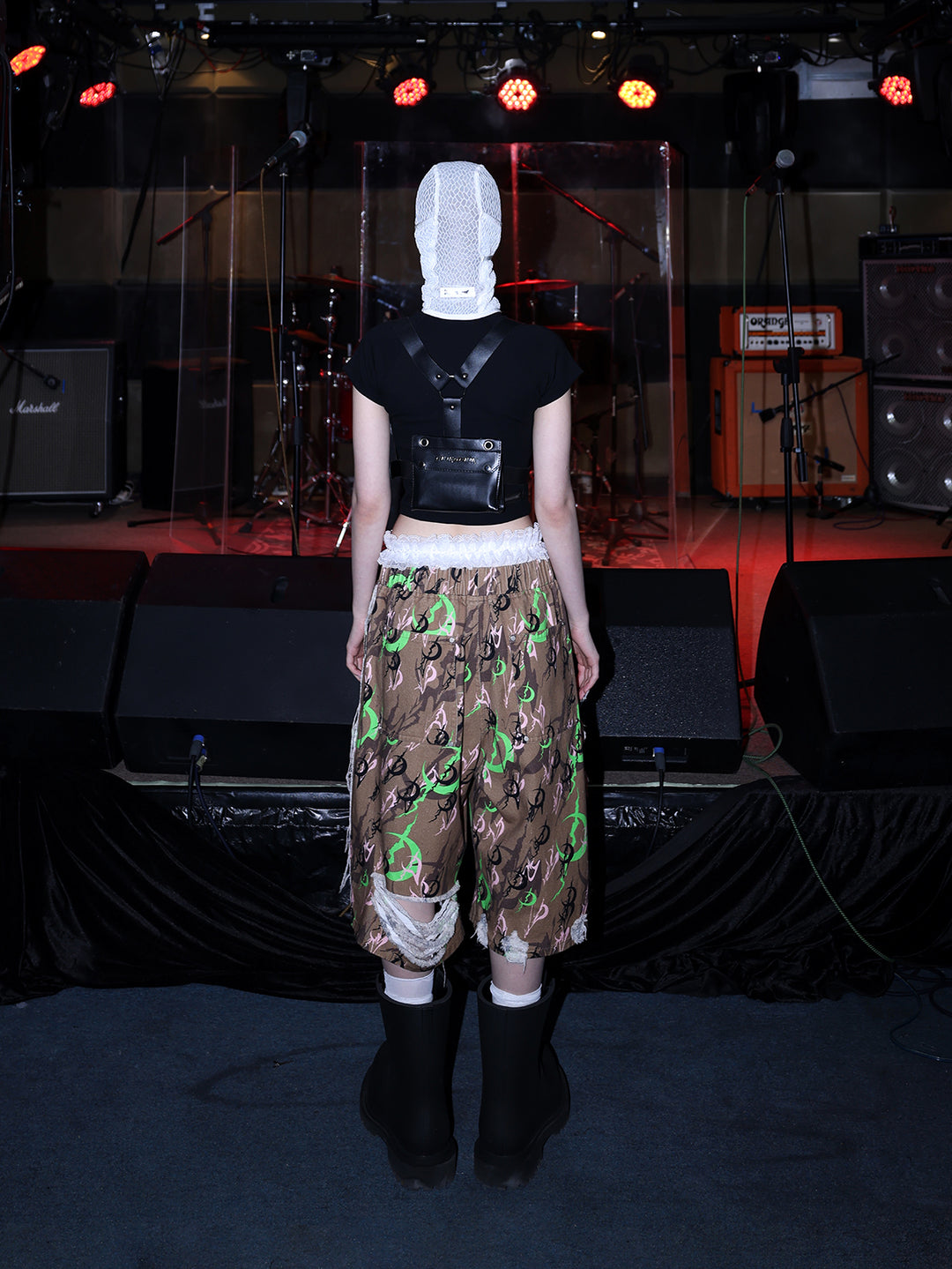 PINKSPINK ELECTRIC MOON distressed camo cropped trousers in CAMOUFLAGE — rear full-body with white hood.