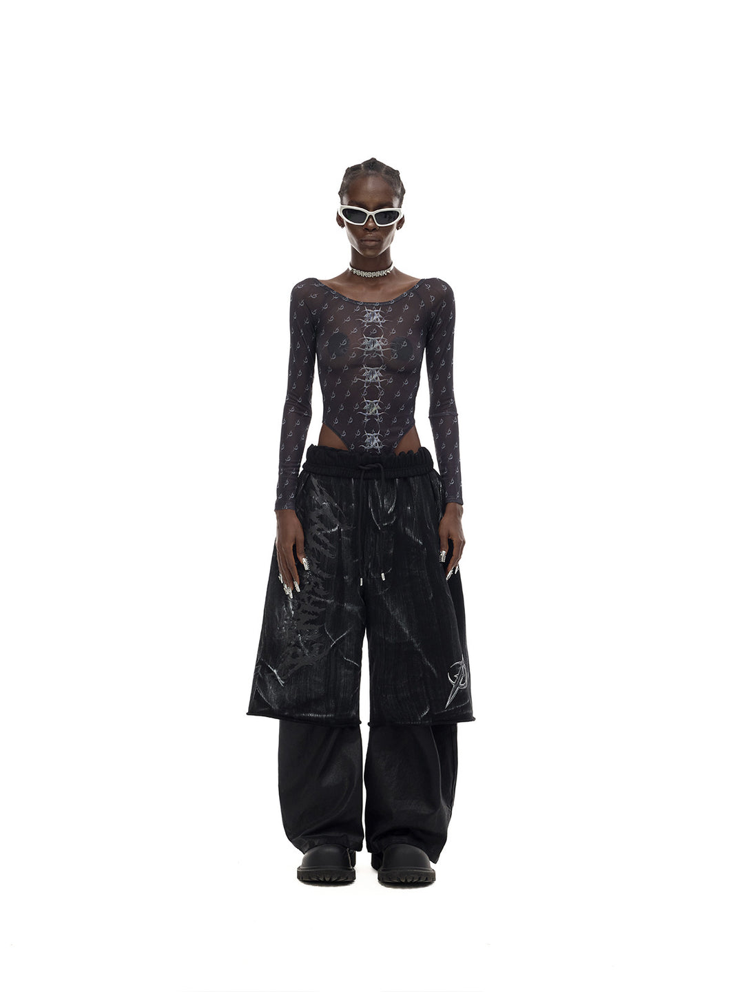 PINKSPINK MIRROR graphic mesh bodysuit in black — front full-length modeled view styled with trousers