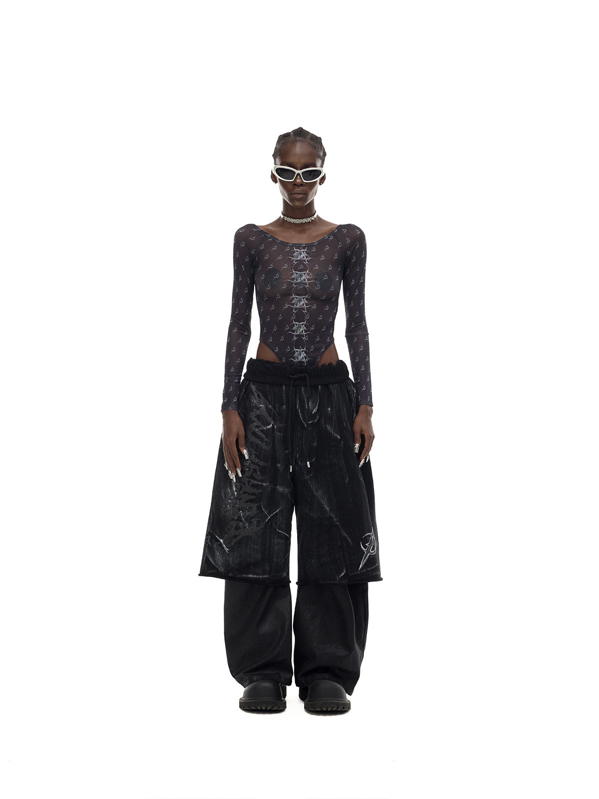 PINKSPINK MIRROR graphic mesh bodysuit in black — front full-length modeled view styled with trousers