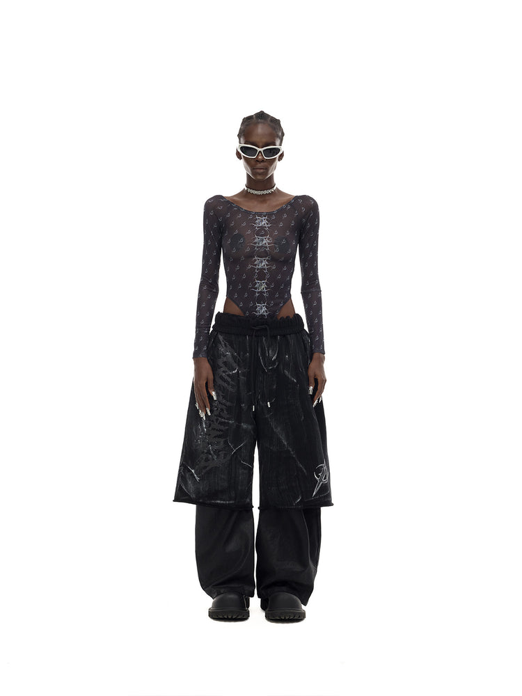 PINKSPINK MIRROR graphic mesh bodysuit in black — front full-length modeled view styled with trousers
