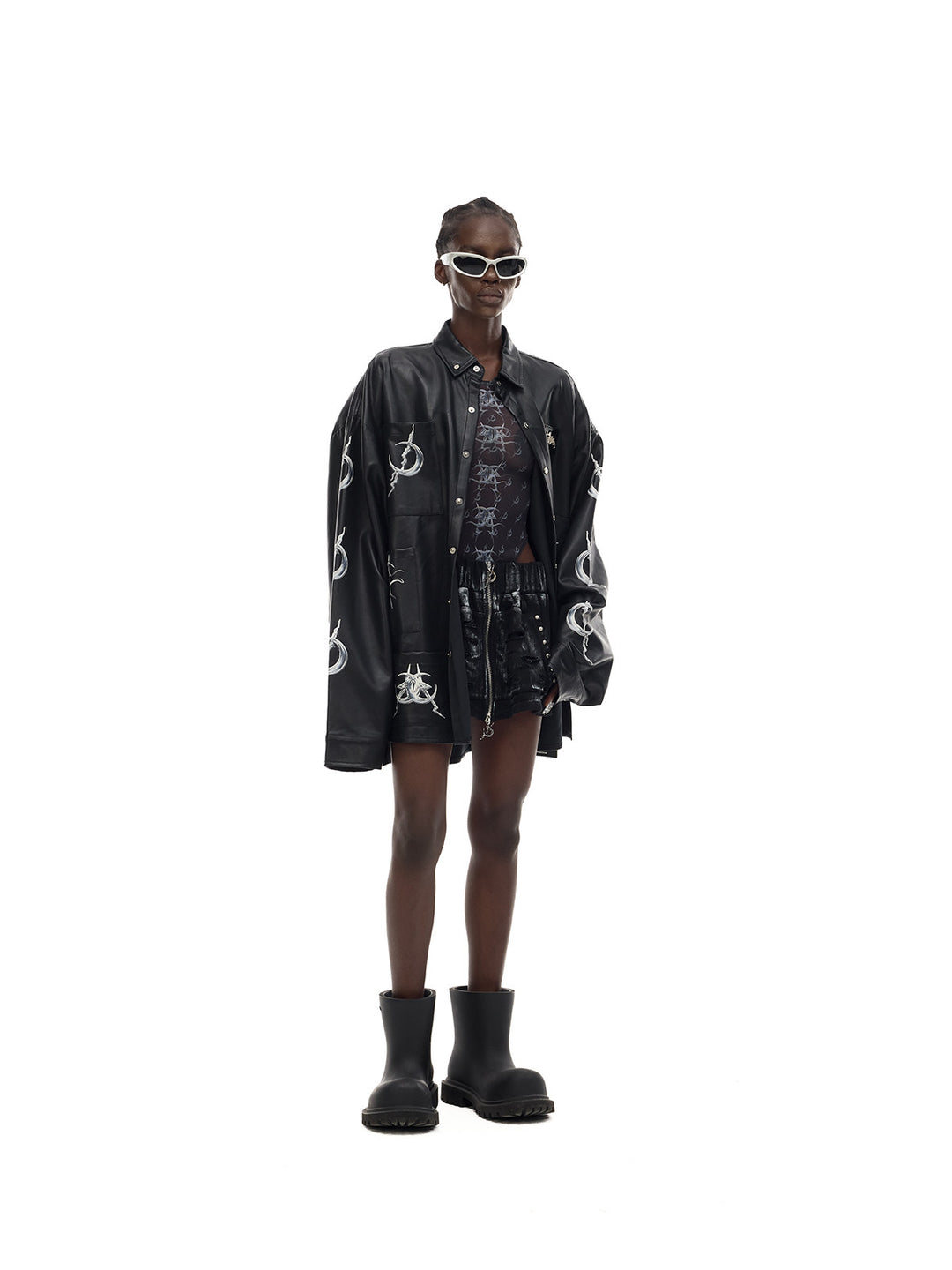 PINKSPINK MIRROR graphic mesh bodysuit in black — opposite three-quarter styling view under a separate jacket