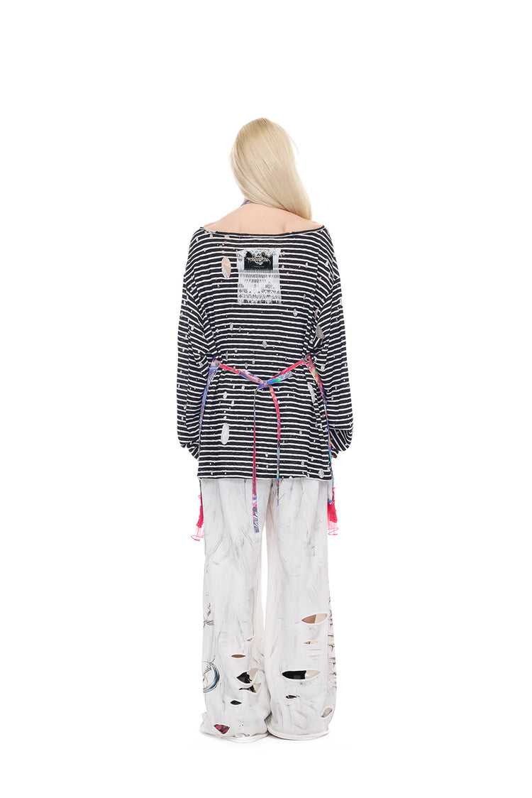 PINKSPINK HORNED FROG ruffle-trim layering apron in pink multicolor — rear full-length modeled view showing the open back and waist ties