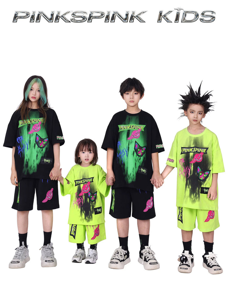 PINKSPINK COLLISION kids graffiti tee and shorts set — group modeled front view of the black and neon-green outfits
