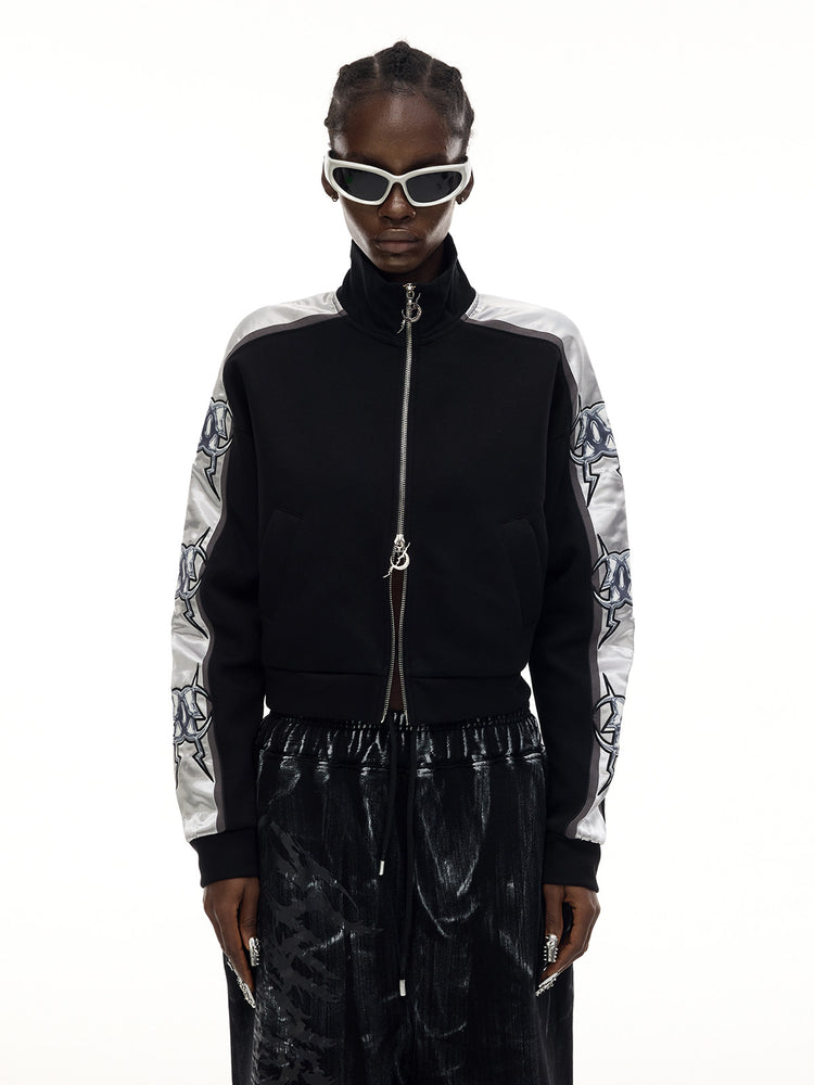 PINKSPINK MIRROR silver-panel zip jacket in black and silver — front modeled close-up with arms lowered