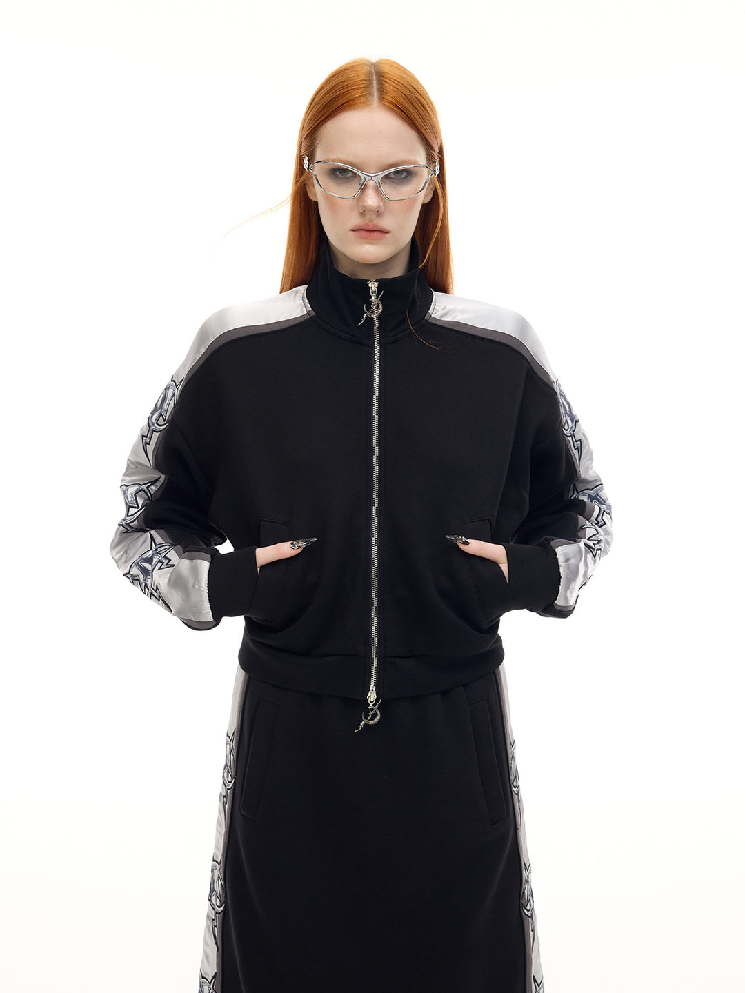 PINKSPINK MIRROR silver-panel zip jacket in black and silver — front modeled close-up showing the pockets and double zipper
