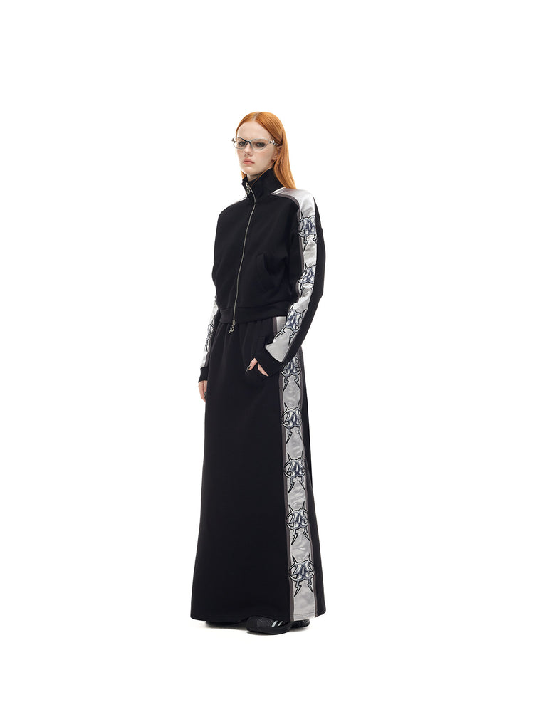 PINKSPINK MIRROR silver-panel zip jacket in black and silver — three-quarter full-length modeled view showing the silver sleeve panel