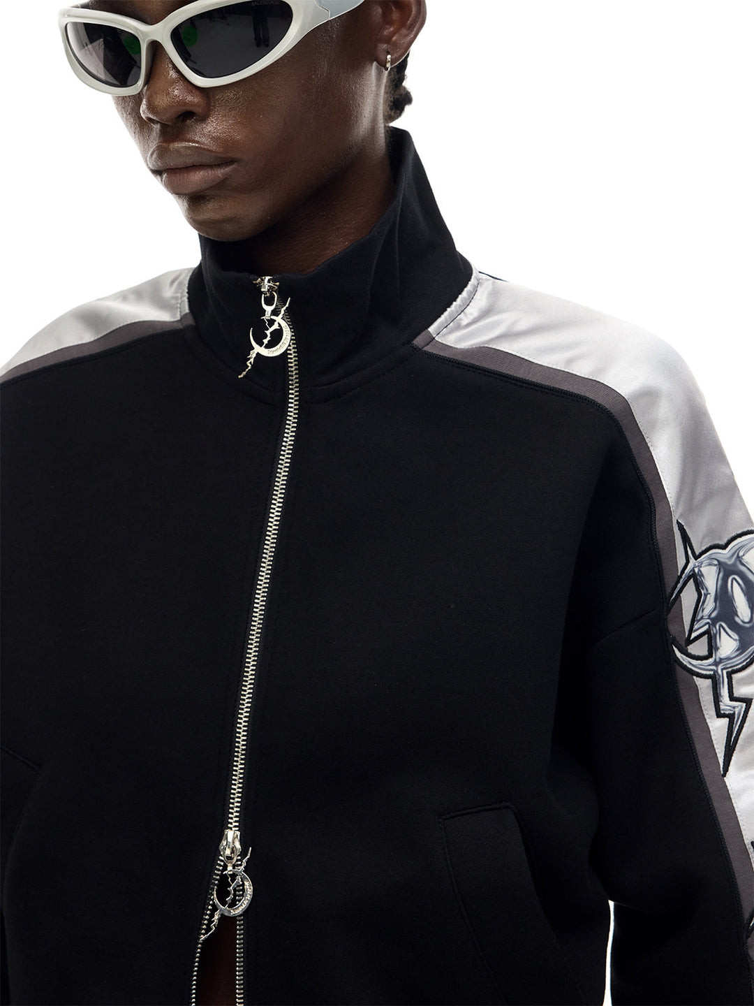 PINKSPINK MIRROR silver-panel zip jacket in black and silver — close-up of the stand collar and crescent zipper pull