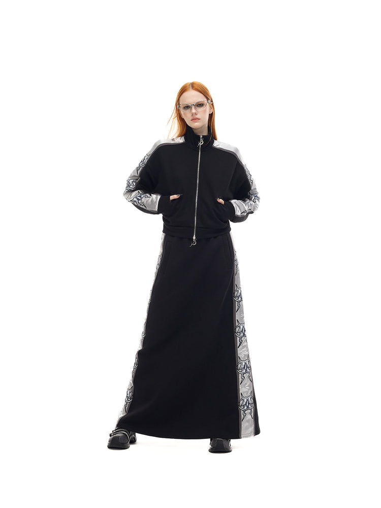 PINKSPINK MIRROR silver-panel maxi skirt in black and silver — front full-length modeled view with a wide stance