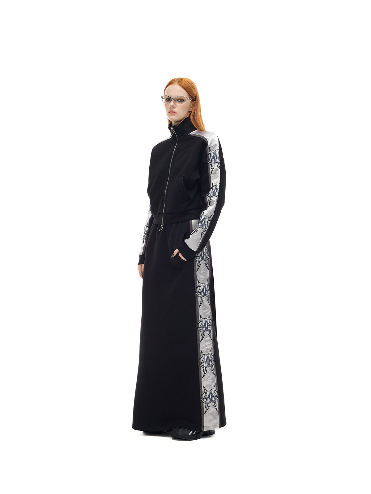 PINKSPINK MIRROR silver-panel maxi skirt in black and silver — three-quarter full-length modeled view styled with the matching jacket