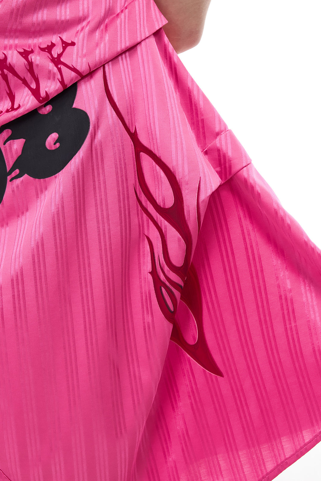 PINKSPINK asymmetric graphic halter dress in pink — close-up of the layered panels, flame graphic and stripe texture