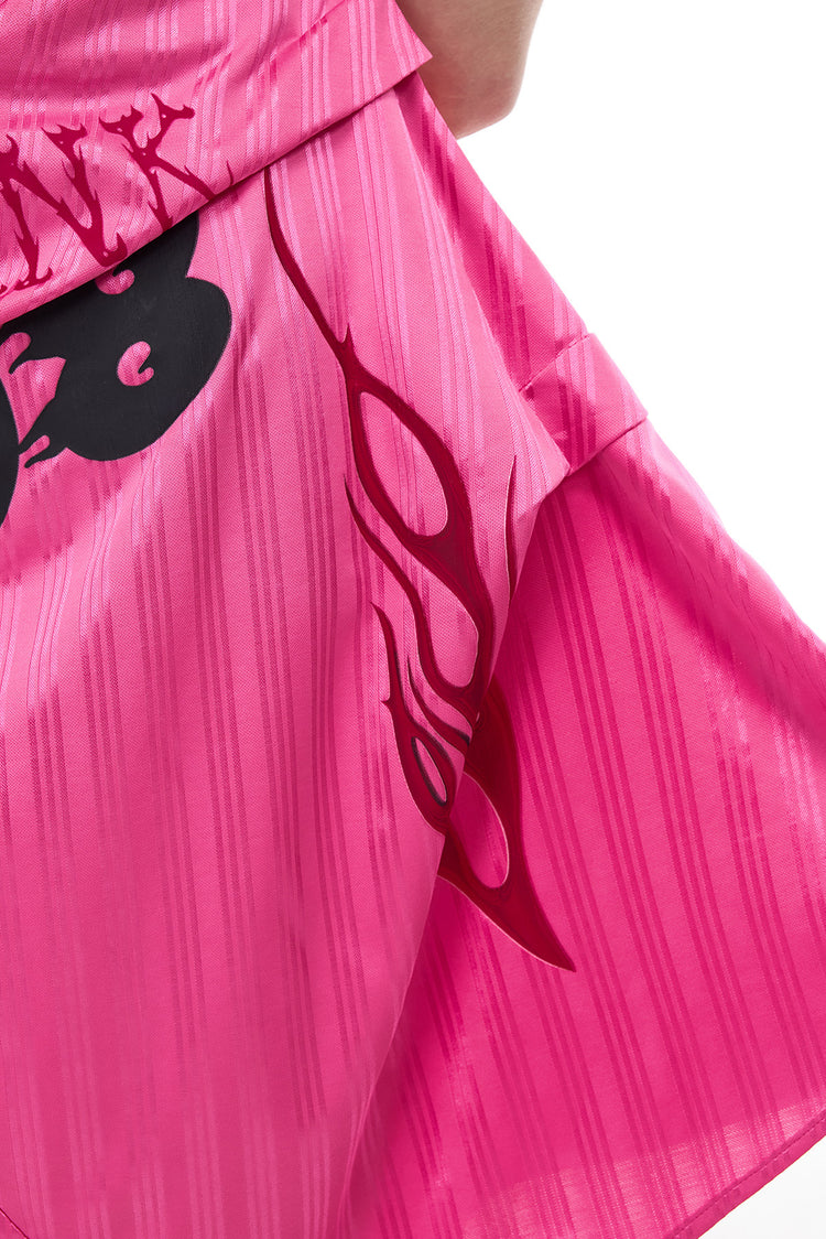 PINKSPINK asymmetric graphic halter dress in pink — close-up of the layered panels, flame graphic and stripe texture