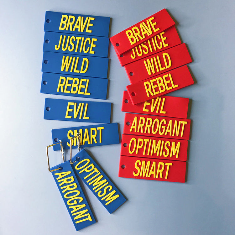 EOH-STUDIO BTBM red and blue word earring panels arranged with metal attachment examples; pieces sold individually.