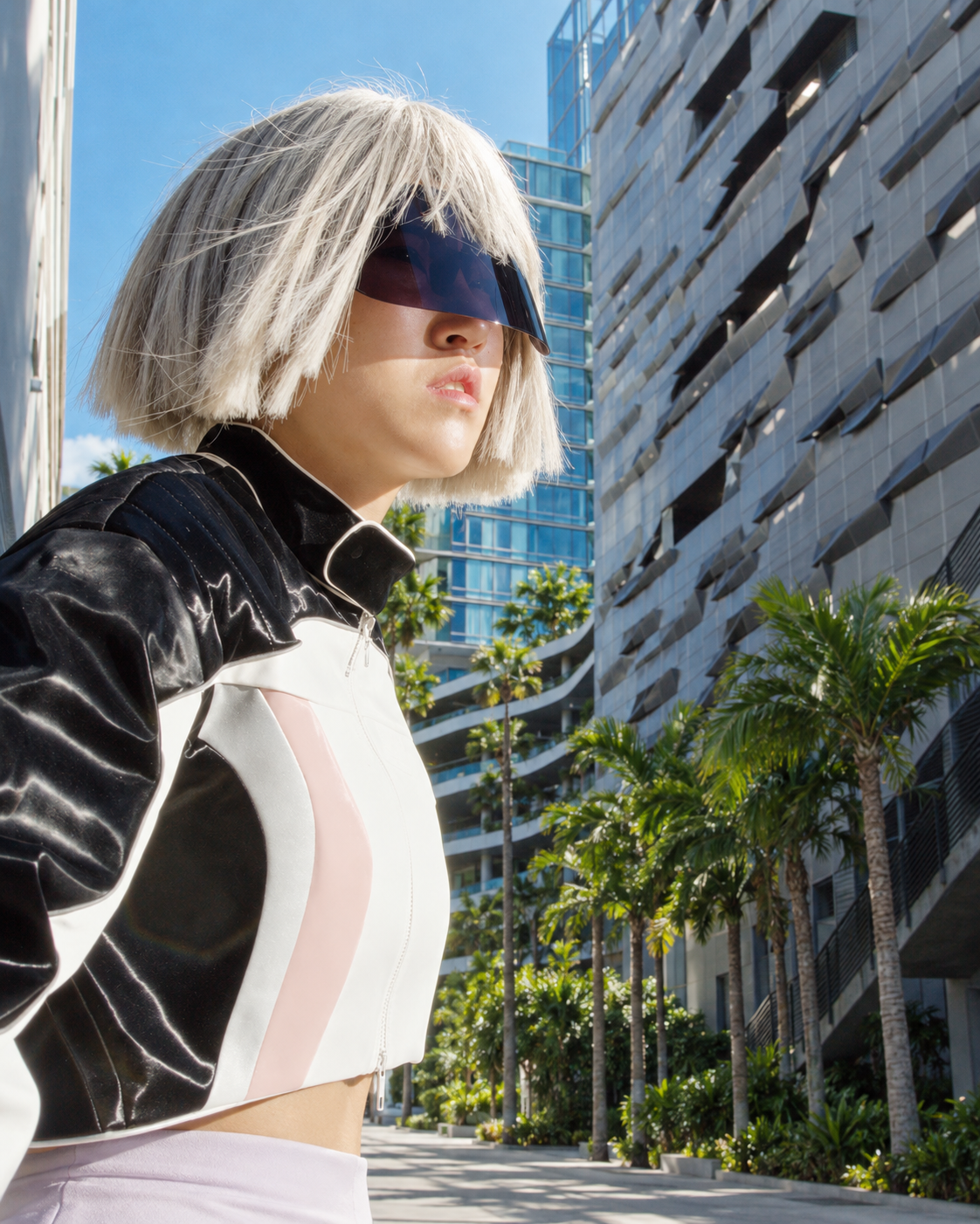 Blue Zone future-self character in a white visor against a futuristic city