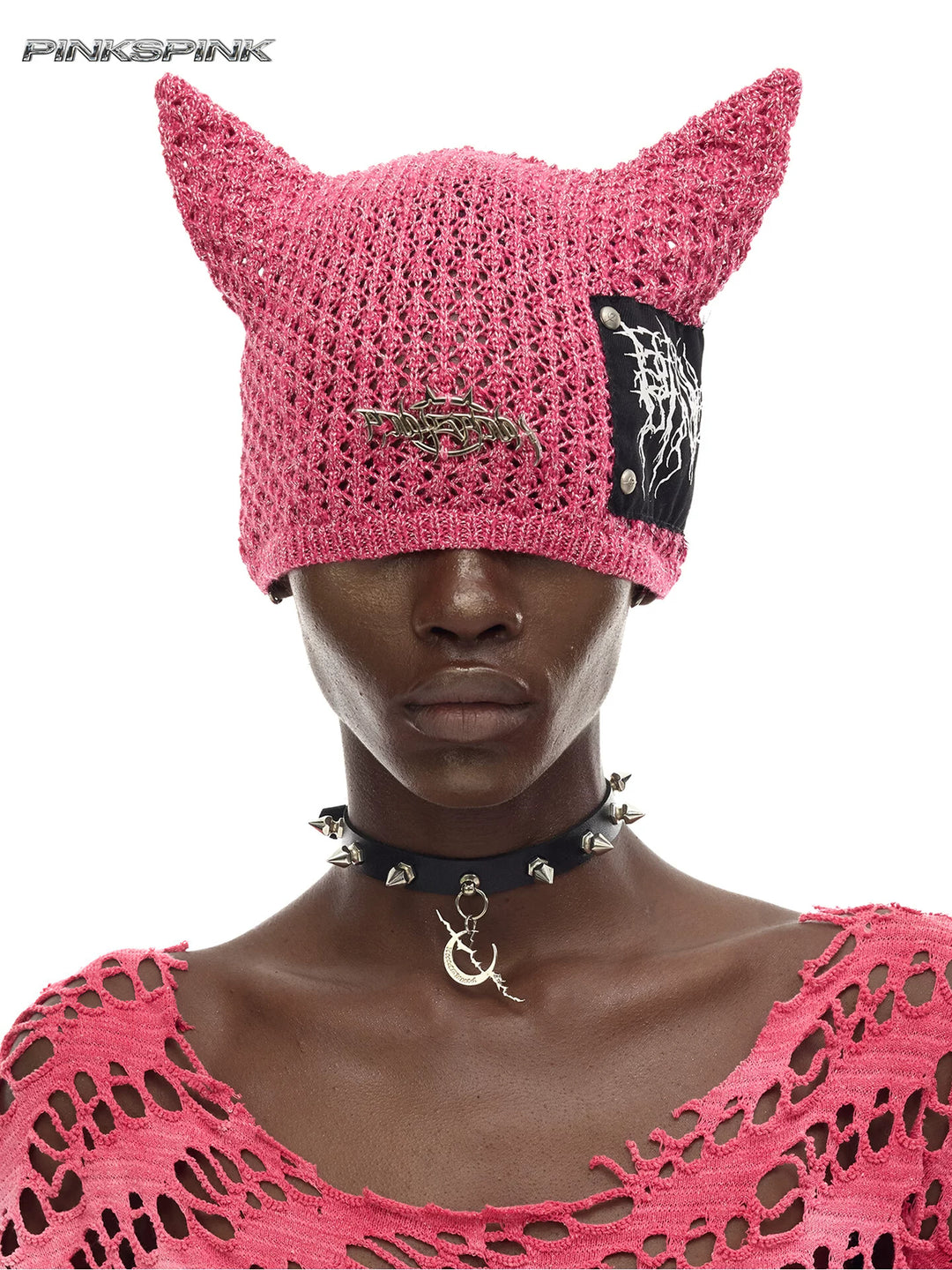 PINKSPINK DEVILCAT distressed cat-ear knit beanie in pink — front modeled close-up with pointed ears and graphic patch