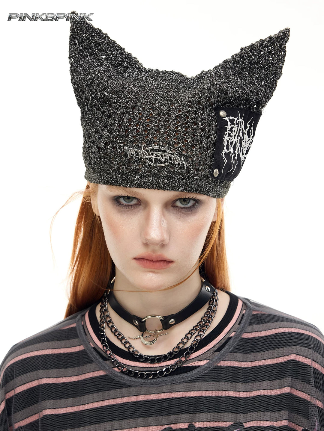 PINKSPINK DEVILCAT distressed cat-ear knit beanie in black — front modeled close-up showing the knit and patch