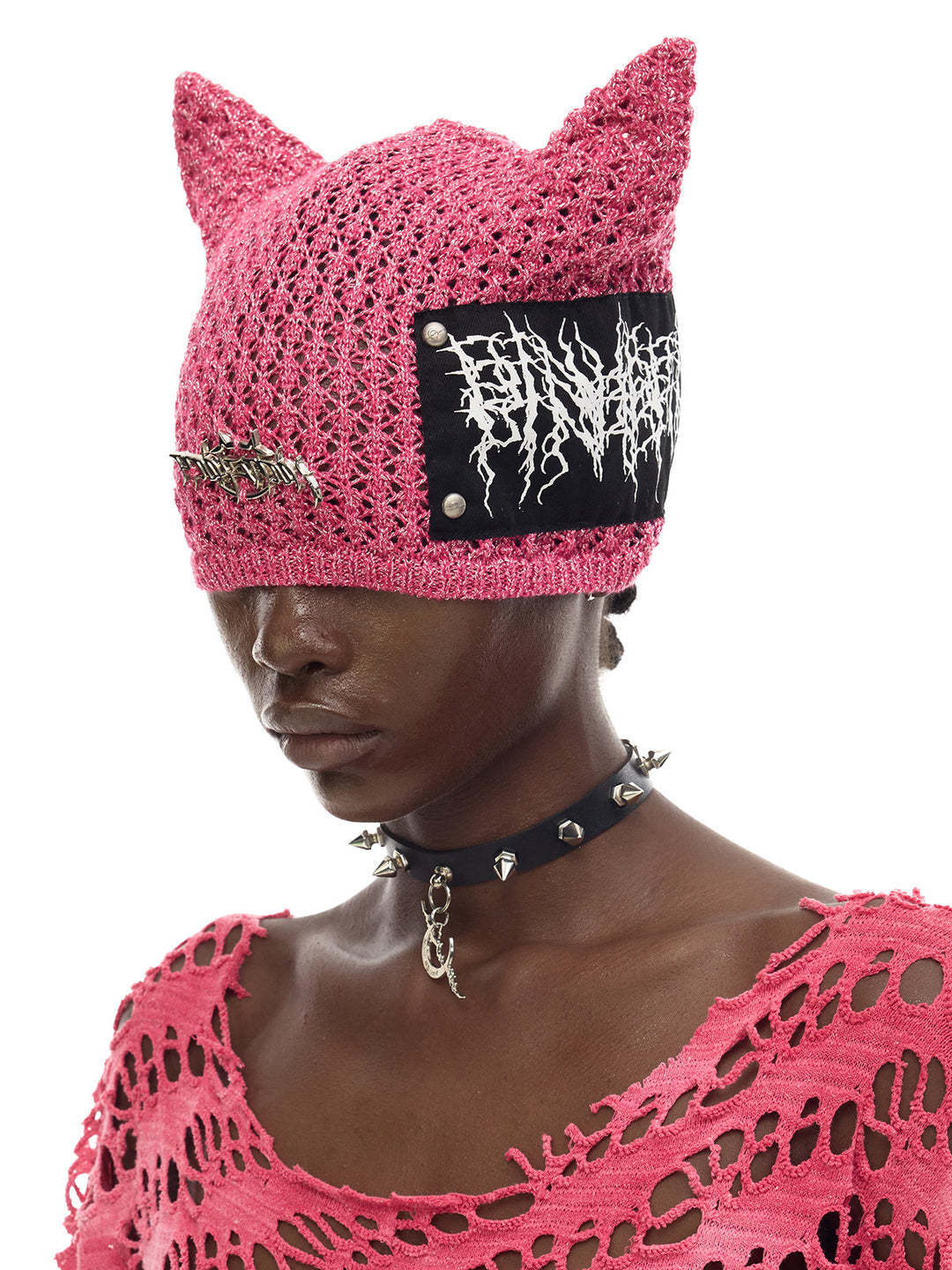 PINKSPINK DEVILCAT distressed cat-ear knit beanie in pink — side modeled close-up showing the ear and patch