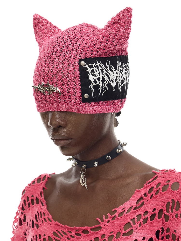 PINKSPINK DEVILCAT distressed cat-ear knit beanie in pink — side modeled close-up showing the ear and patch