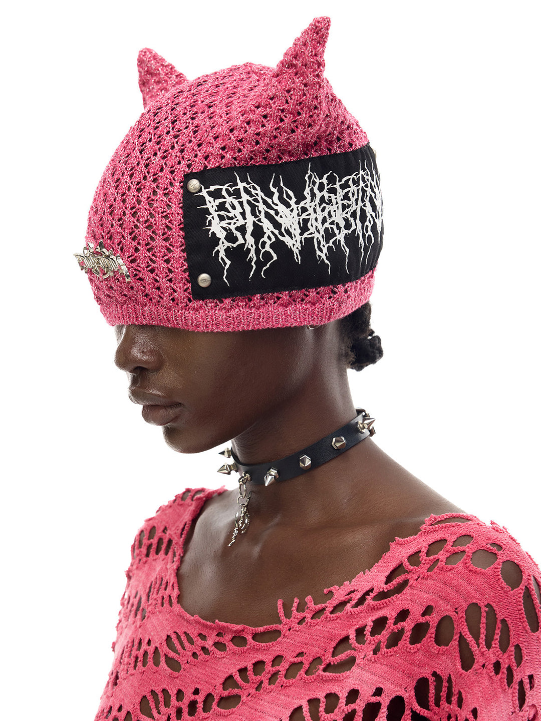 PINKSPINK DEVILCAT distressed cat-ear knit beanie in pink — three-quarter modeled portrait with contrasting patch