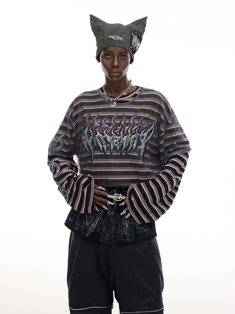 PINKSPINK DEVILCAT distressed cat-ear knit beanie in black — three-quarter front modeled outfit view with a striped tee
