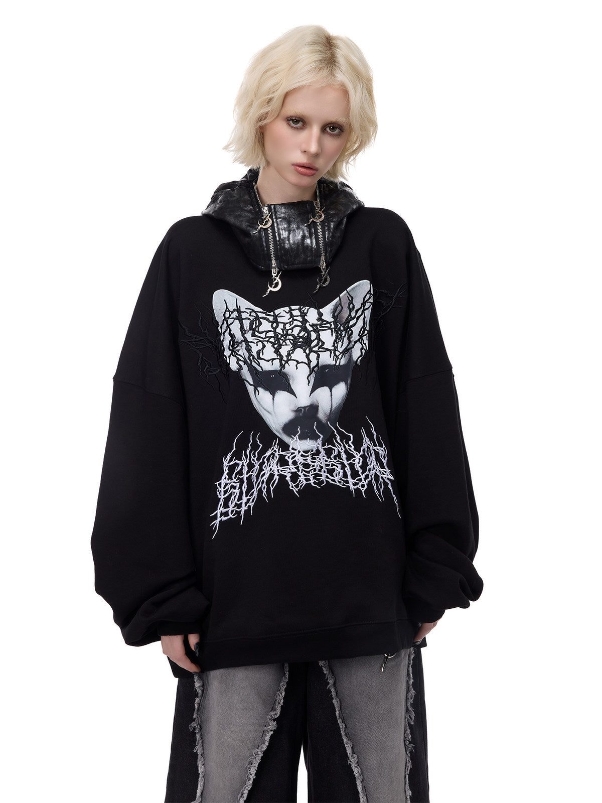 PINKSPINK ELECTRIC MOON metallic double-zip balaclava in metallic black — front modeled view worn down with a graphic sweatshirt