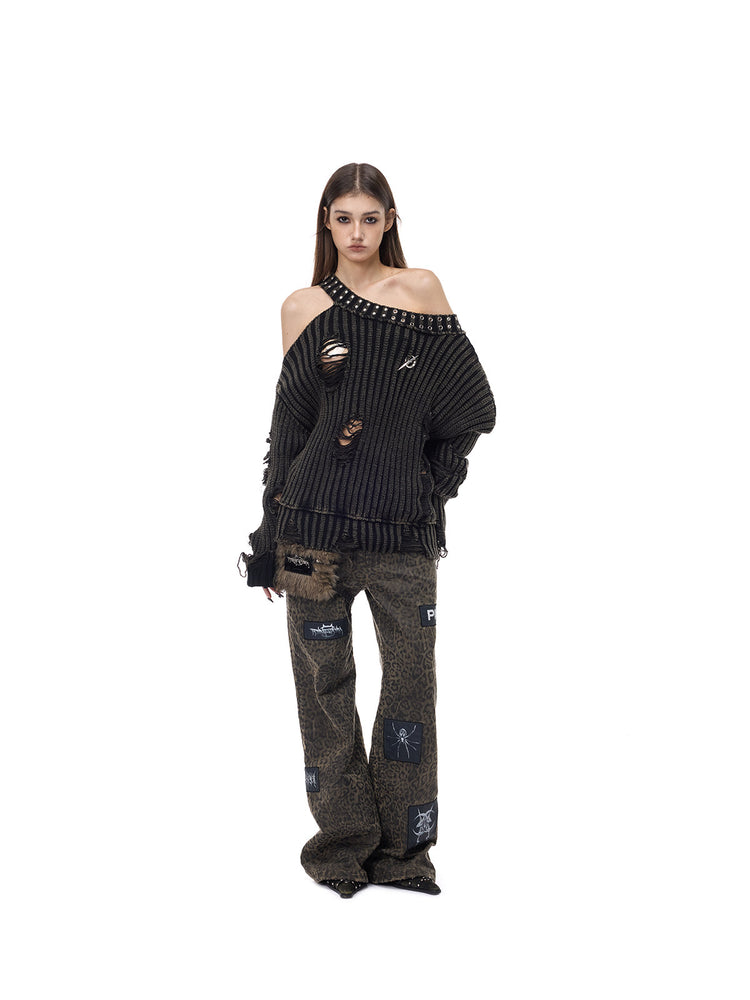 PINKSPINK ELECTRIC MOON distressed studded cold-shoulder sweater in washed black — front kneeling modeled pose showing the long sleeves