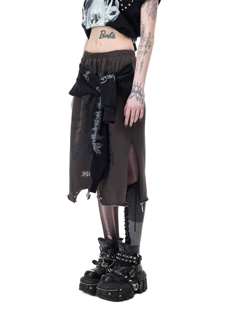 PINKSPINK REMAKE convertible thorn skirt in black gray — angled close modeled view of the skirt’s side opening and tied sleeves