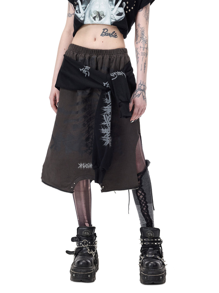 PINKSPINK REMAKE convertible thorn skirt in black gray — angled front modeled view showing the skirt’s elastic waist, thorn graphics and side opening