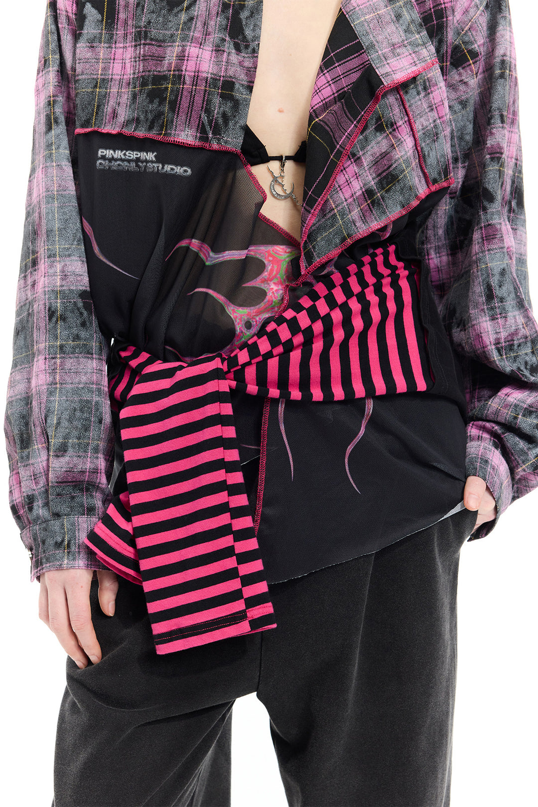 PINKSPINK REMAKE striped patchwork shirt dress in black and pink — close-up of the tied striped sleeves and printed mesh at the waist