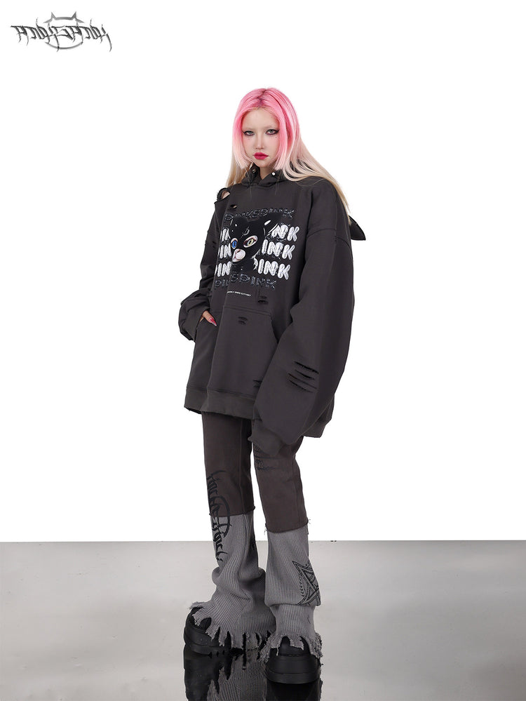 PINKSPINK DEVON CAT distressed mask hoodie in gray — front modeled view with a relaxed sideways lean and gray trousers