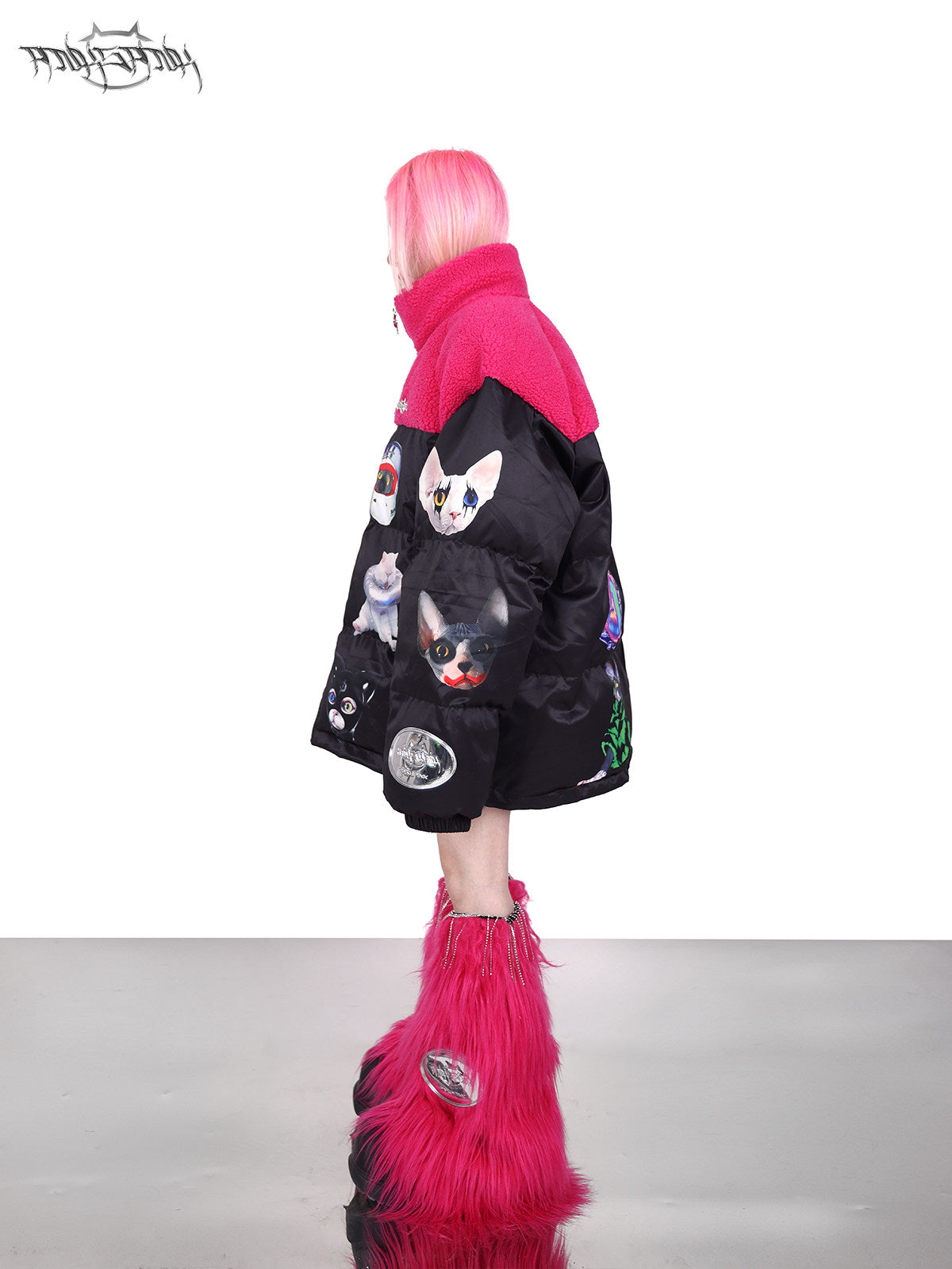 PINKSPINK CAT COSMOS fleece-yoke padded jacket in black pink — left-side full-length modeled view showing the sleeve graphics