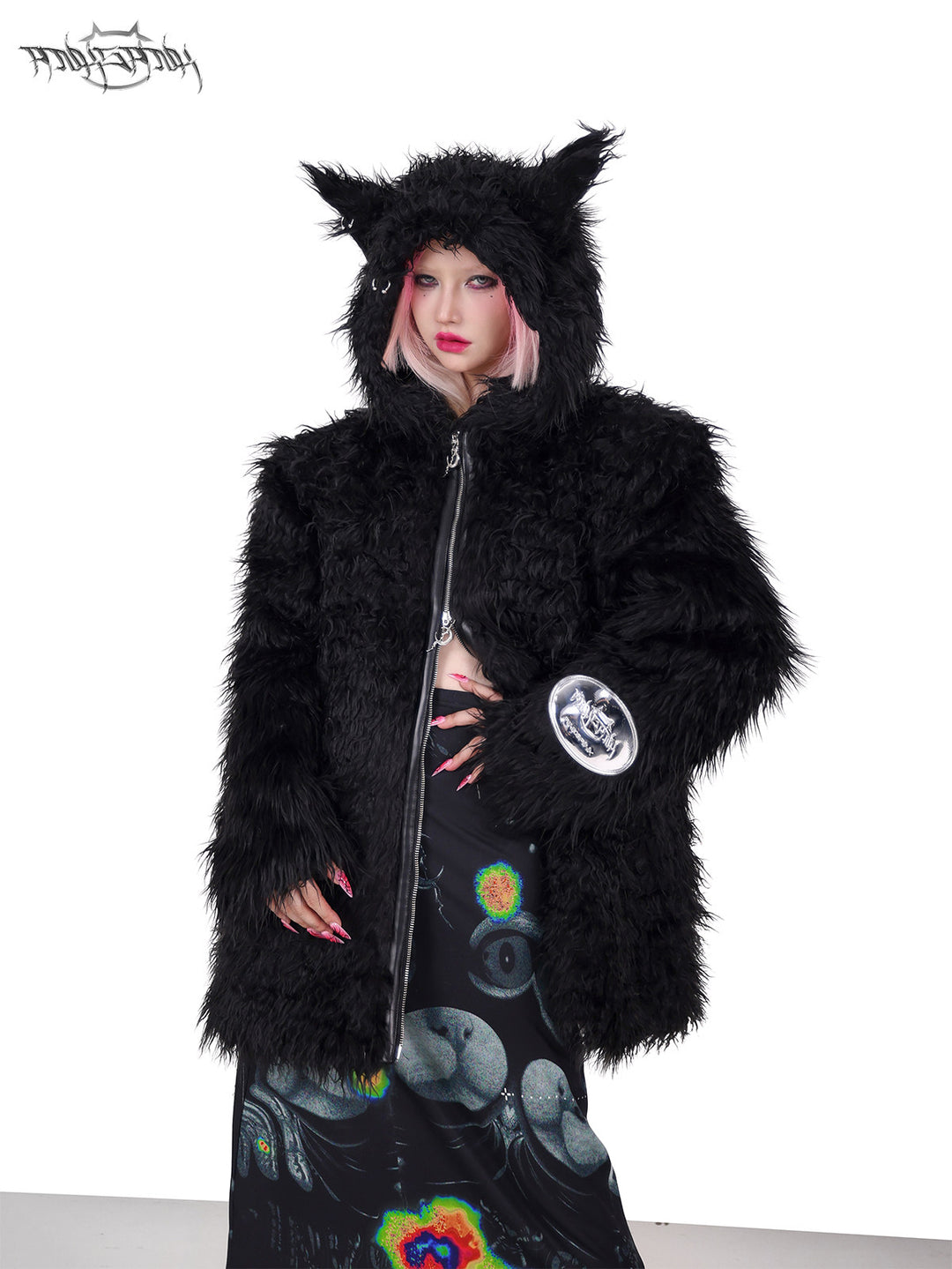 PINKSPINK DEVIL CAT pierced faux-fur jacket in black — front modeled close-up with one hand at the waist
