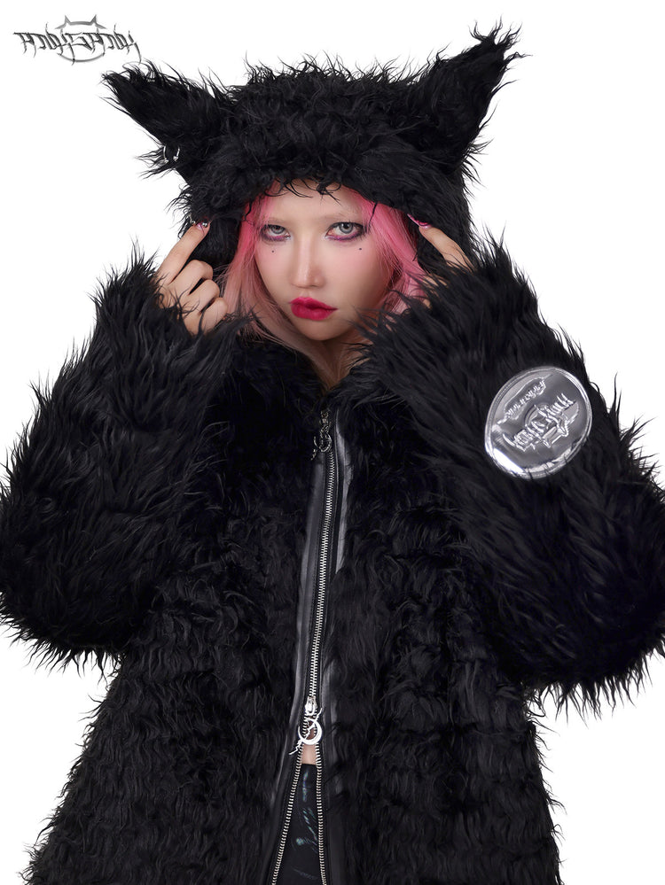 PINKSPINK DEVIL CAT pierced faux-fur jacket in black — close-up of the pierced cat-ear hood with hands at the temples