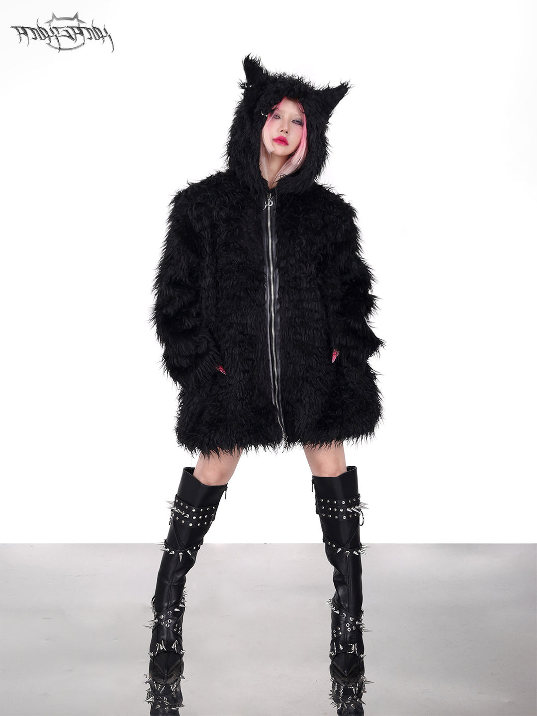 PINKSPINK DEVIL CAT pierced faux-fur jacket in black — front full-length modeled view with hands in the pockets