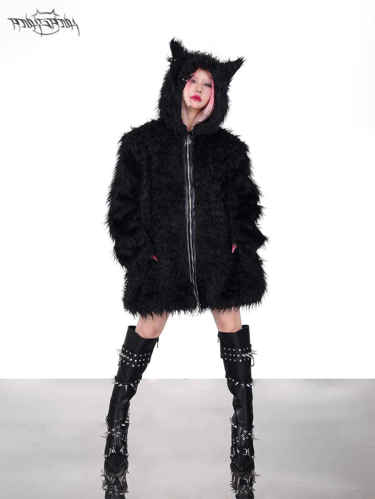 PINKSPINK DEVIL CAT pierced faux-fur jacket in black — front full-length modeled view with hands in the pockets