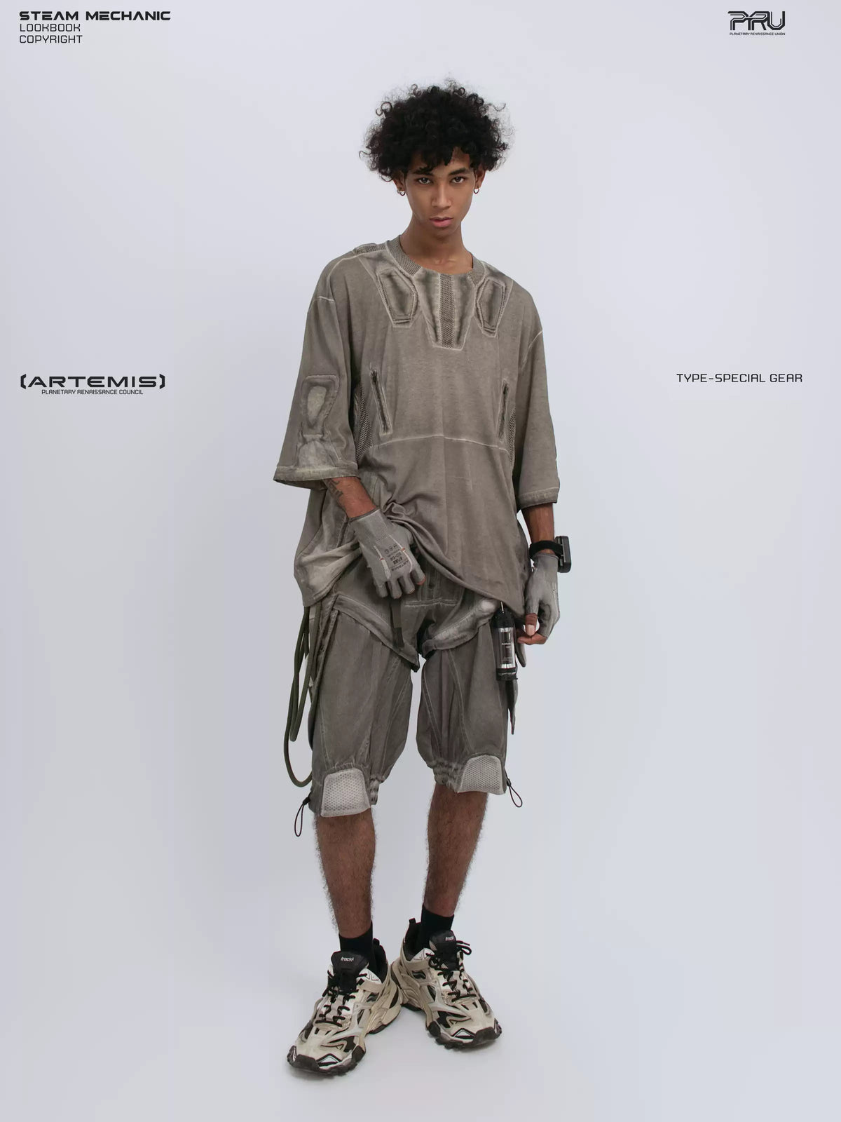 STARCORE xirang brown distressed mesh tee — full-length front view with one hand holding the hem and one foot turned outward