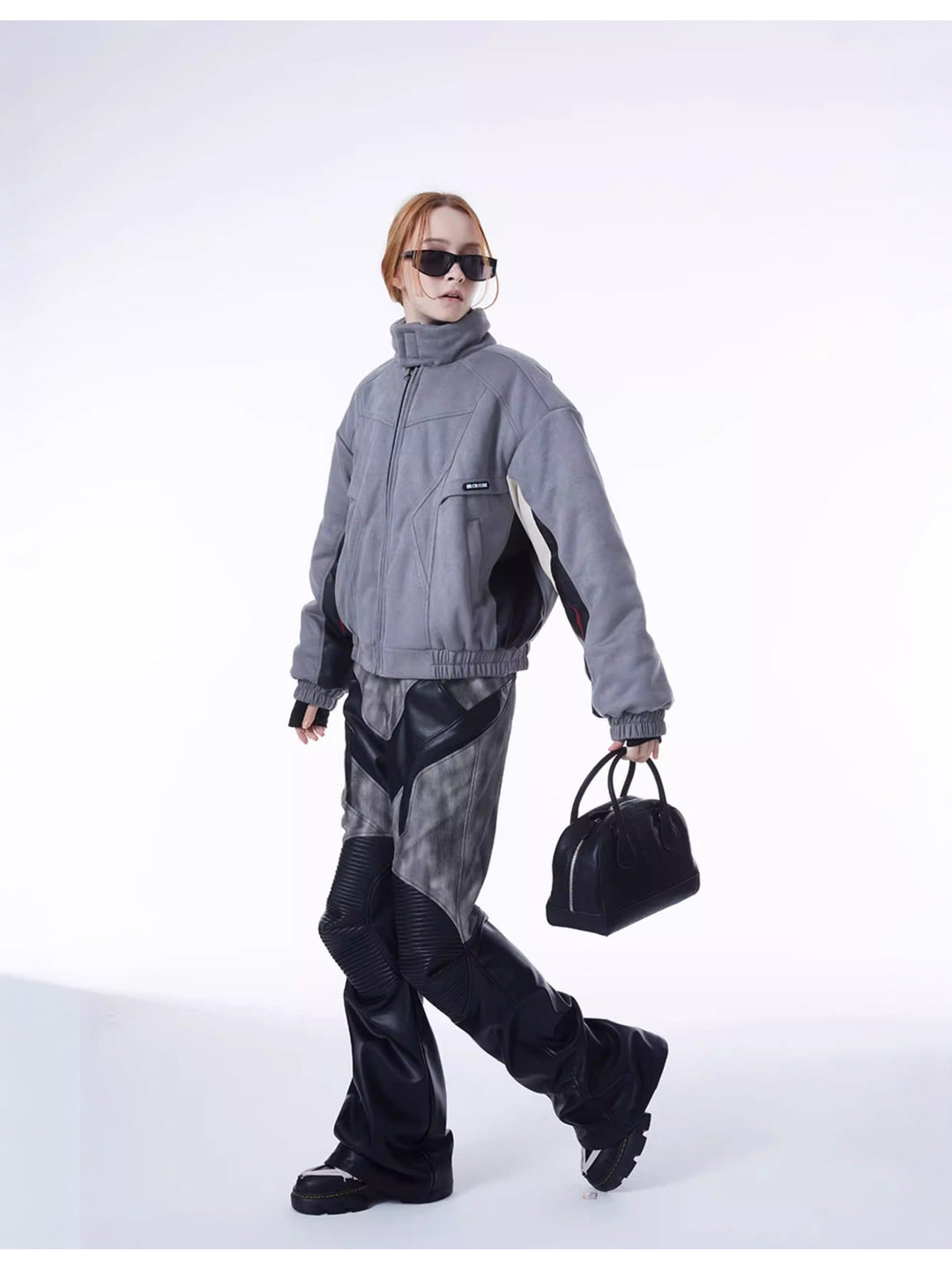 ERRORCODE ROBOT haze-blue contrast-panel padded racing jacket, front walking view showing the broad padded silhouette